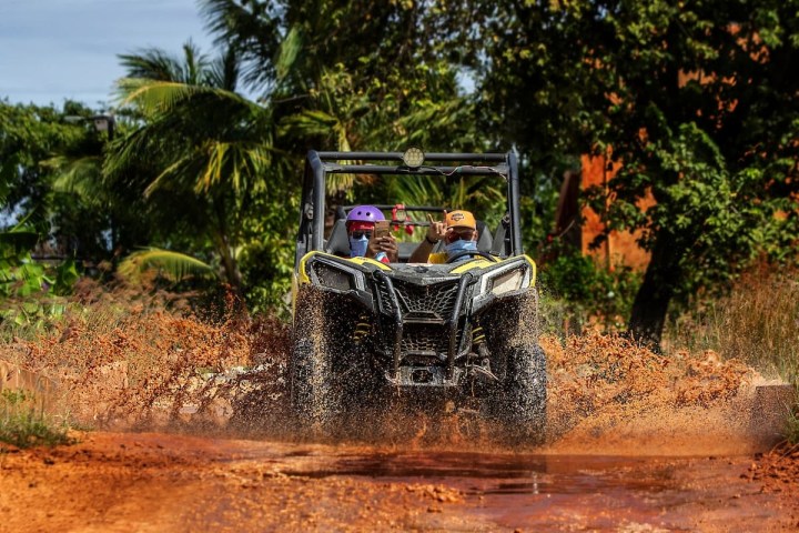 a bus driving down a dirt road